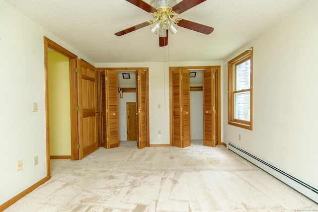 132 Wade Rd, Pomfret, CT 06259 - unfurnished bedroom featuring a baseboard radiator, two closets, carpet floors, a textured ceiling, and ceiling fan