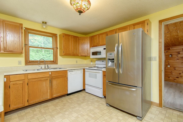 132 Wade Rd, Pomfret, CT 06259 - kitchen with white appliances, light countertops, and brown cabinetry