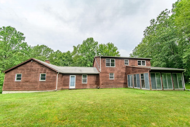 132 Wade Rd, Pomfret, CT 06259 - back of property featuring a sunroom, a lawn, and a chimney