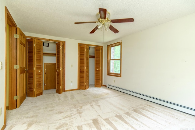 132 Wade Rd, Pomfret, CT 06259 - unfurnished bedroom with a baseboard heating unit, multiple closets, light carpet, a textured ceiling, and ceiling fan