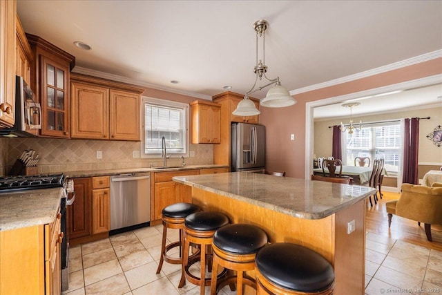 70 Albemarle St, Bridgeport, CT 06606 - kitchen featuring stainless steel appliances, light tile patterned floors, backsplash, a center island, and ornamental molding