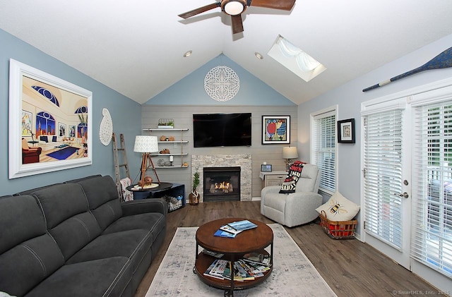 362 Main St, Meriden, CT 06451 - living area with wood finished floors, ceiling fan, vaulted ceiling, a stone fireplace, and a skylight