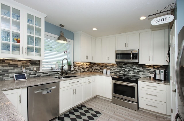 362 Main St, Meriden, CT 06451 - kitchen with appliances with stainless steel finishes, white cabinetry, decorative backsplash, decorative light fixtures, and recessed lighting