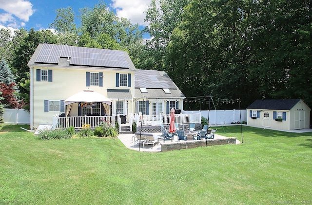 362 Main St, Meriden, CT 06451 - back of house with a gazebo, a patio, roof mounted solar panels, a shed, and a deck