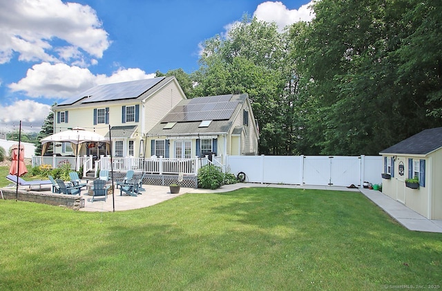 362 Main St, Meriden, CT 06451 - back of house with a patio area, a gate, a fenced backyard, roof mounted solar panels, and a wooden deck