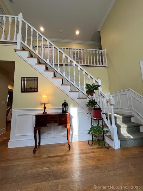 47 Merwin Brook Rd, Brookfield, CT 06804 - stairway with crown molding, a decorative wall, wood finished floors, a wainscoted wall, and recessed lighting