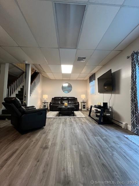 47 Merwin Brook Rd, Brookfield, CT 06804 - living room with wood finished floors, stairs, and a drop ceiling