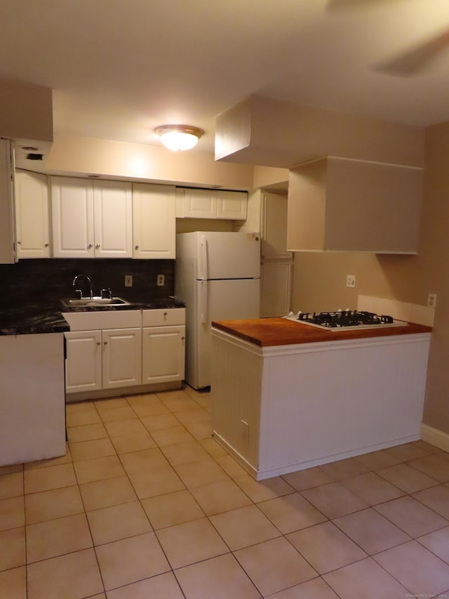 1 Birch Ln Unit D, East Haven, CT 06513 - kitchen featuring white appliances, dark countertops, white cabinets, light tile patterned floors, and backsplash