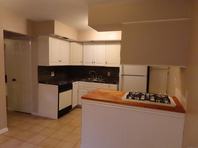 1 Birch Ln Unit D, East Haven, CT 06513 - kitchen with white appliances, white cabinets, light tile patterned floors, and dark countertops