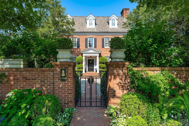 354 S Ave, New Canaan, CT 06840 - view of front of property with a fenced front yard, a gate, and brick siding