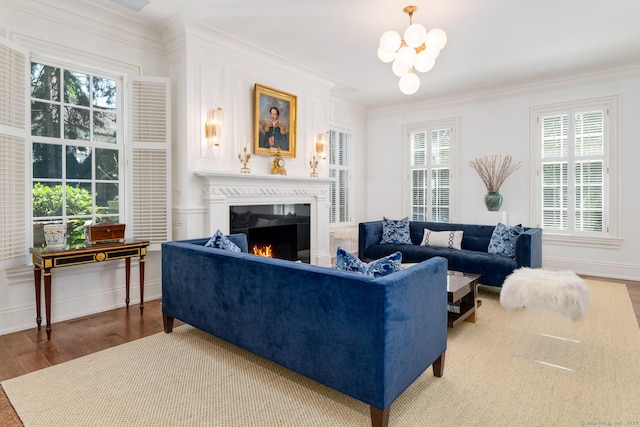 354 S Ave, New Canaan, CT 06840 - living area featuring wood finished floors, a chandelier, a lit fireplace, and crown molding
