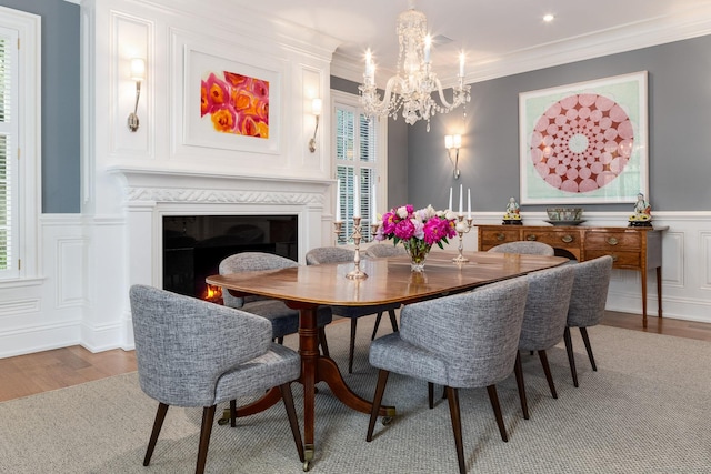 354 S Ave, New Canaan, CT 06840 - dining area with wood finished floors, plenty of natural light, a chandelier, a decorative wall, and wainscoting