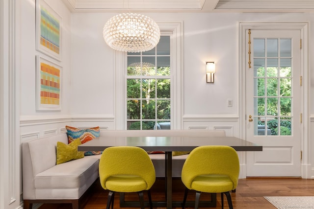 354 S Ave, New Canaan, CT 06840 - dining room featuring a decorative wall, a chandelier, wood finished floors, plenty of natural light, and wainscoting