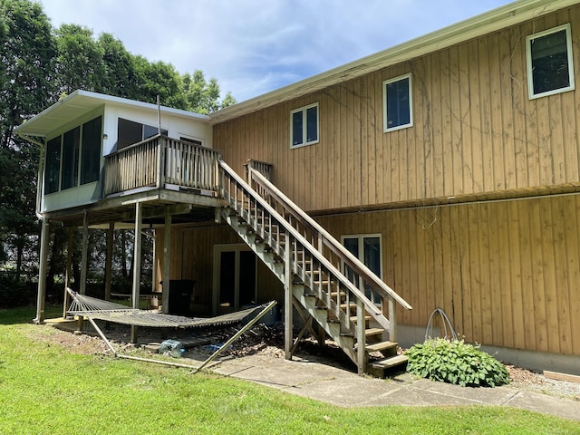 127 Nicole Dr, Milford, CT 06460 - rear view of property featuring stairway, a deck, and a sunroom