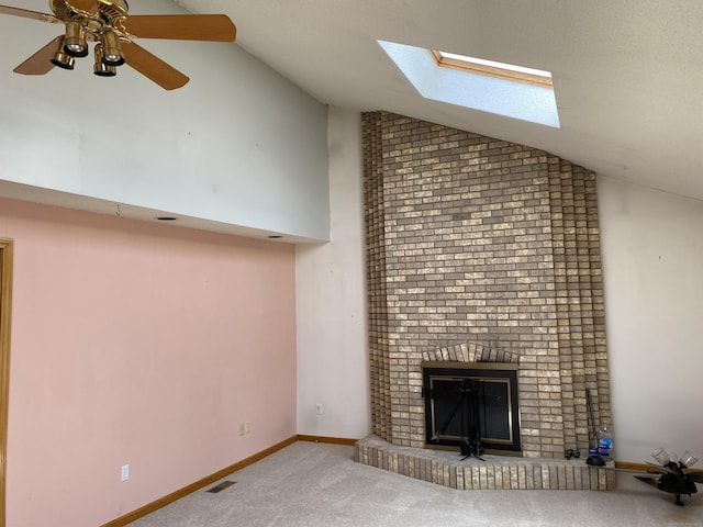 127 Nicole Dr, Milford, CT 06460 - unfurnished living room featuring lofted ceiling, carpet floors, a skylight, a fireplace, and a ceiling fan