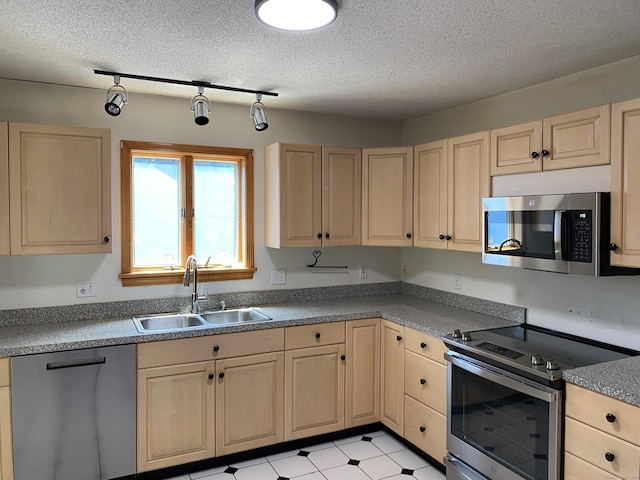 127 Nicole Dr, Milford, CT 06460 - kitchen with appliances with stainless steel finishes, light brown cabinetry, and a textured ceiling