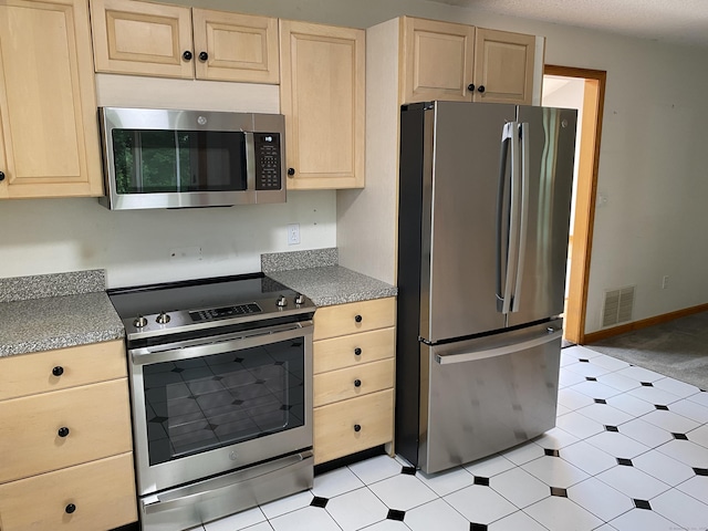 127 Nicole Dr, Milford, CT 06460 - kitchen with appliances with stainless steel finishes, light brown cabinets, and light flooring