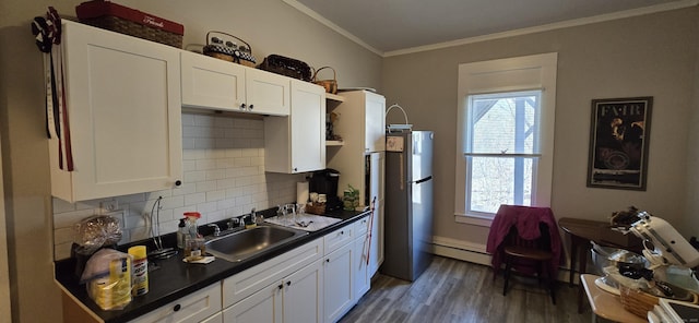 102 Boswell Ave, Norwich, CT 06360 - kitchen featuring dark countertops, plenty of natural light, a baseboard radiator, wood finished floors, and crown molding