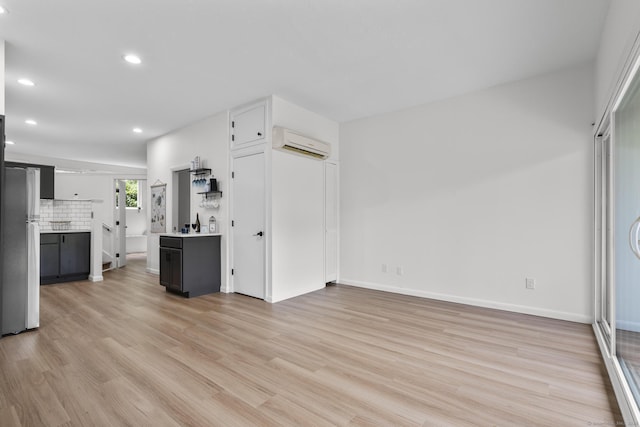 16 Pine Orchard Rd Apt 18, Branford, CT 06405 - unfurnished living room with a wall unit AC, recessed lighting, and light wood-style floors