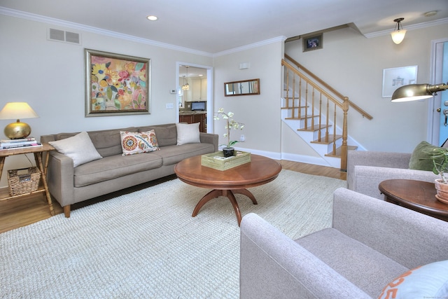 1221 Merritt St, Fairfield, CT 06825 - living area with wood finished floors, crown molding, stairway, and recessed lighting