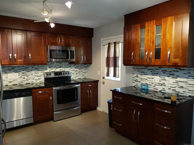 51 Savin Park Unit 51, West Haven, CT 06516 - kitchen featuring appliances with stainless steel finishes, backsplash, light tile patterned floors, and glass insert cabinets