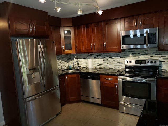51 Savin Park Unit 51, West Haven, CT 06516 - kitchen with appliances with stainless steel finishes, light tile patterned floors, decorative backsplash, and glass insert cabinets