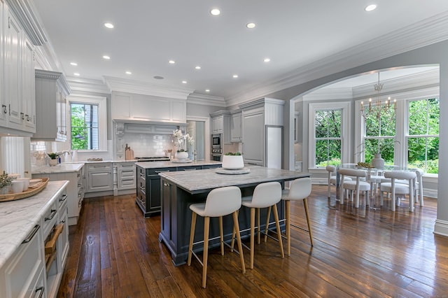 14 Market St, Ridgefield, CT 06877 - kitchen with a center island, appliances with stainless steel finishes, crown molding, gray cabinetry, and dark wood-style floors