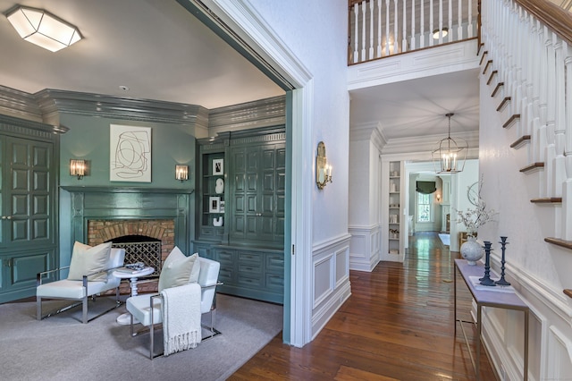 14 Market St, Ridgefield, CT 06877 - foyer with hardwood / wood-style floors, a fireplace, ornamental molding, a decorative wall, and wainscoting