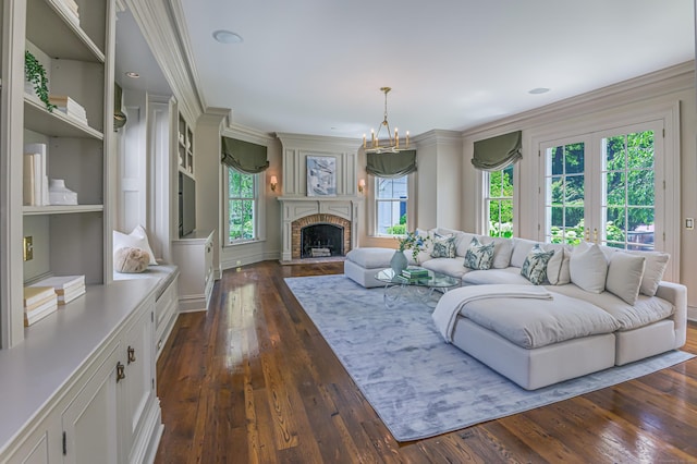 14 Market St, Ridgefield, CT 06877 - living room featuring plenty of natural light, dark wood finished floors, a brick fireplace, a chandelier, and ornamental molding