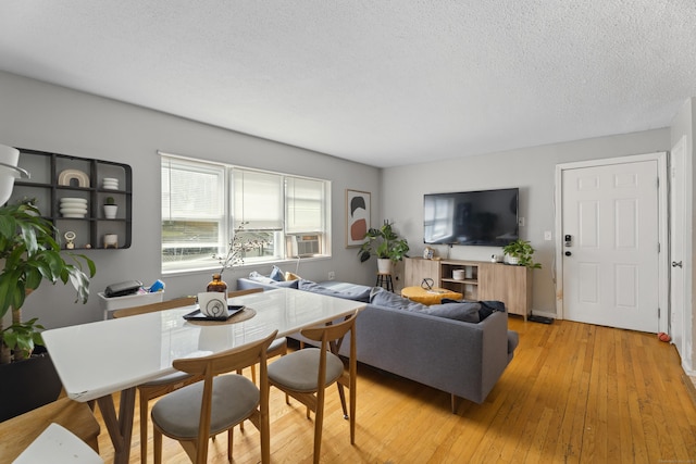 212 Sheffield Ave, New Haven, CT 06511 - living area with light wood finished floors, cooling unit, and a textured ceiling