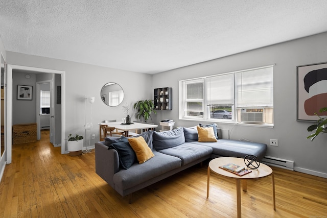 212 Sheffield Ave, New Haven, CT 06511 - living area featuring a textured ceiling, wood-type flooring, cooling unit, and baseboard heating