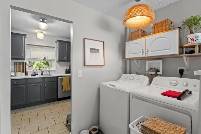 212 Sheffield Ave, New Haven, CT 06511 - washroom featuring cabinet space, washer and dryer, a textured ceiling, and light tile patterned floors