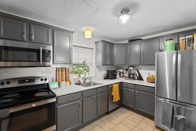 212 Sheffield Ave, New Haven, CT 06511 - kitchen featuring appliances with stainless steel finishes, light countertops, tasteful backsplash, gray cabinetry, and light tile patterned flooring