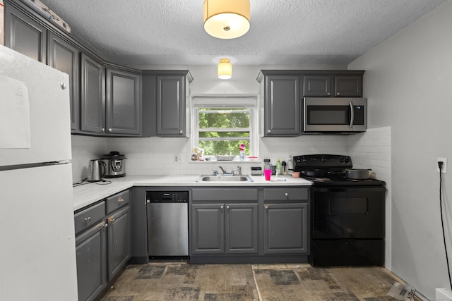 212 Sheffield Ave, New Haven, CT 06511 - kitchen with appliances with stainless steel finishes, gray cabinetry, a textured ceiling, tasteful backsplash, and light countertops