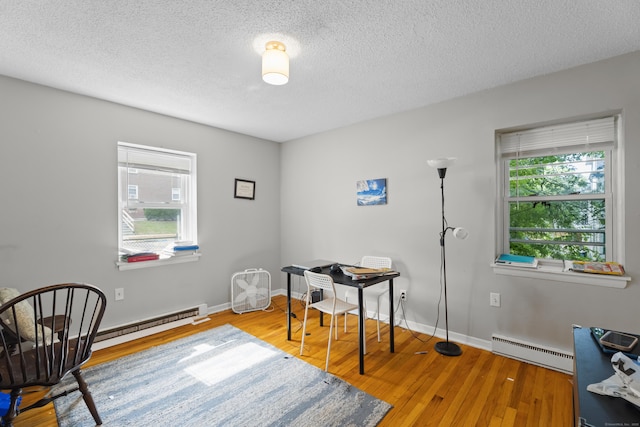 212 Sheffield Ave, New Haven, CT 06511 - home office with a baseboard heating unit, wood finished floors, and a textured ceiling