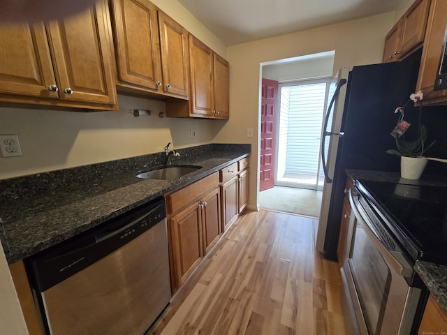 655 Talcottville Rd Apt 89, Vernon, CT 06066 - kitchen with stainless steel appliances, light wood-style flooring, brown cabinetry, and dark stone countertops