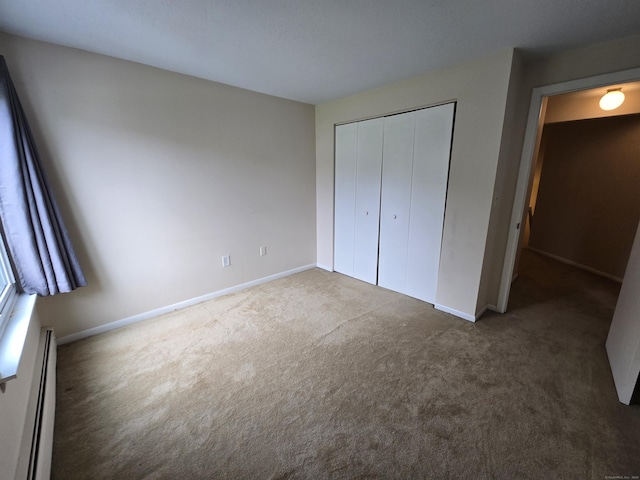655 Talcottville Rd Apt 89, Vernon, CT 06066 - unfurnished bedroom featuring baseboard heating, carpet, and a closet