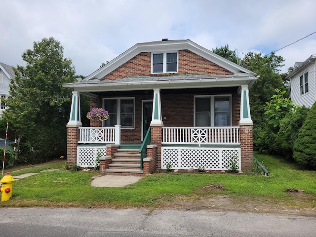 50 Tracy Ave, Waterbury, CT 06706 - view of front of home featuring brick siding, a porch, and a front yard