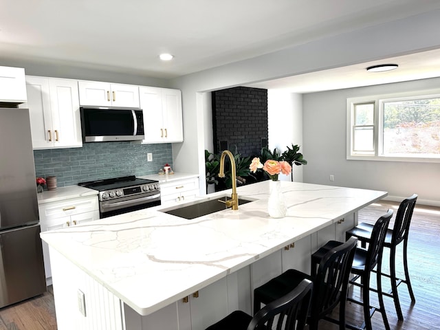 26 Nejako Dr, Middletown, CT 06457 - kitchen featuring appliances with stainless steel finishes, white cabinetry, light stone counters, wood finished floors, and recessed lighting
