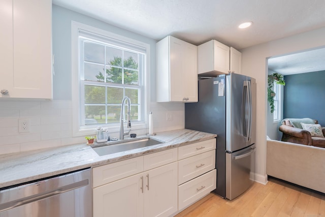 282 Montgomery Rd, Westfield, MA 01085 - kitchen featuring appliances with stainless steel finishes, light wood finished floors, white cabinets, light stone counters, and recessed lighting