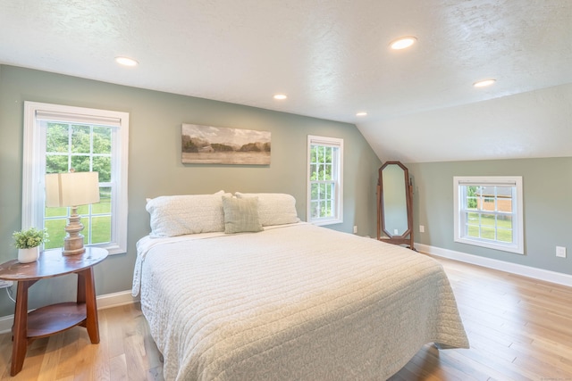 282 Montgomery Rd, Westfield, MA 01085 - bedroom with multiple windows, light wood finished floors, lofted ceiling, recessed lighting, and a textured ceiling
