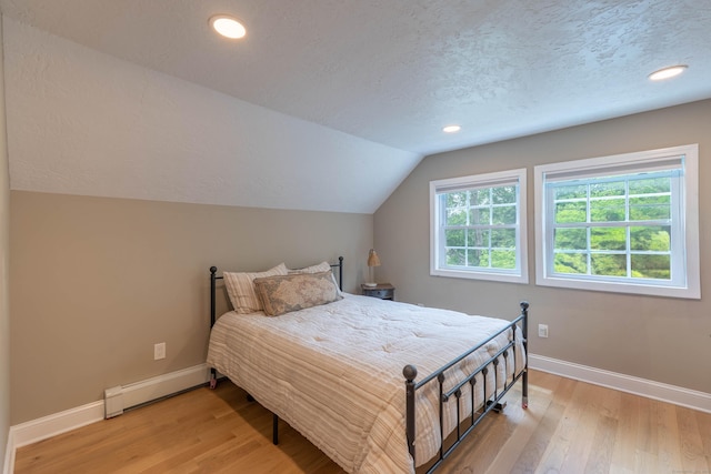 282 Montgomery Rd, Westfield, MA 01085 - bedroom featuring a baseboard heating unit, light wood-type flooring, vaulted ceiling, a textured ceiling, and recessed lighting