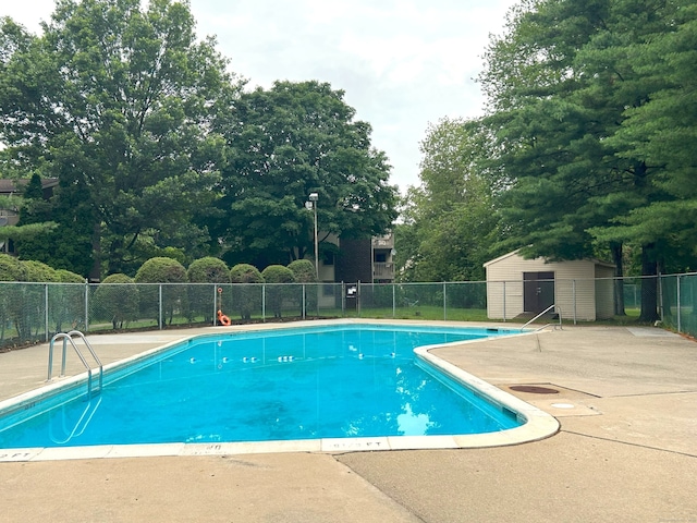 7 Padanaram Rd Unit C75, Danbury, CT 06811 - community pool featuring a patio area and view of scattered trees
