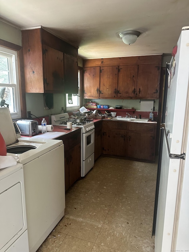 5 Obtuse Rocks Rd, Brookfield, CT 06804 - kitchen featuring white appliances, washer and clothes dryer, healthy amount of natural light, and brown cabinets