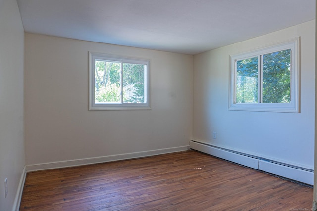156 Overhill Dr, Berlin, CT 06037 - empty room featuring a baseboard heating unit, plenty of natural light, and wood finished floors