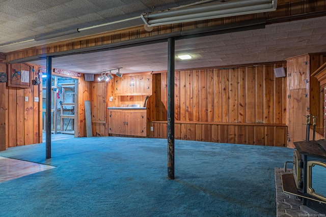 156 Overhill Dr, Berlin, CT 06037 - finished basement featuring carpet flooring, wood walls, and a wood stove
