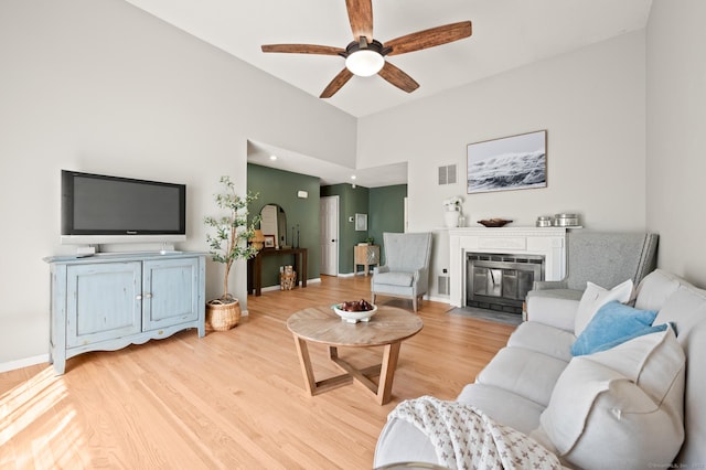 578 Pilgrim Hbr Unit 578, Wallingford, CT 06492 - living area with ceiling fan, light wood-type flooring, a fireplace with flush hearth, and a high ceiling