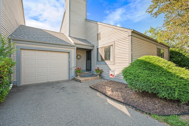 578 Pilgrim Hbr Unit 578, Wallingford, CT 06492 - mid-century inspired home featuring a garage, driveway, a chimney, and roof with shingles