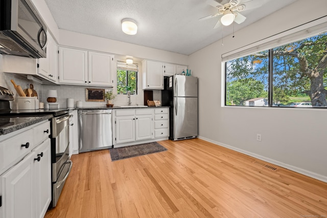 578 Pilgrim Hbr Unit 578, Wallingford, CT 06492 - kitchen with stainless steel appliances, decorative backsplash, ceiling fan, white cabinetry, and a textured ceiling