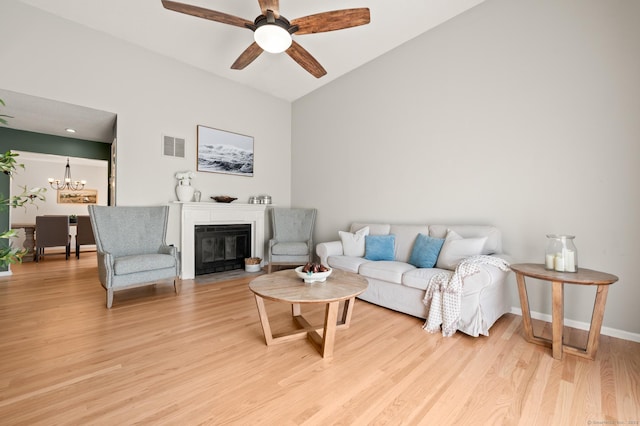 578 Pilgrim Hbr Unit 578, Wallingford, CT 06492 - living room with vaulted ceiling, light wood finished floors, ceiling fan, a chandelier, and a fireplace with flush hearth